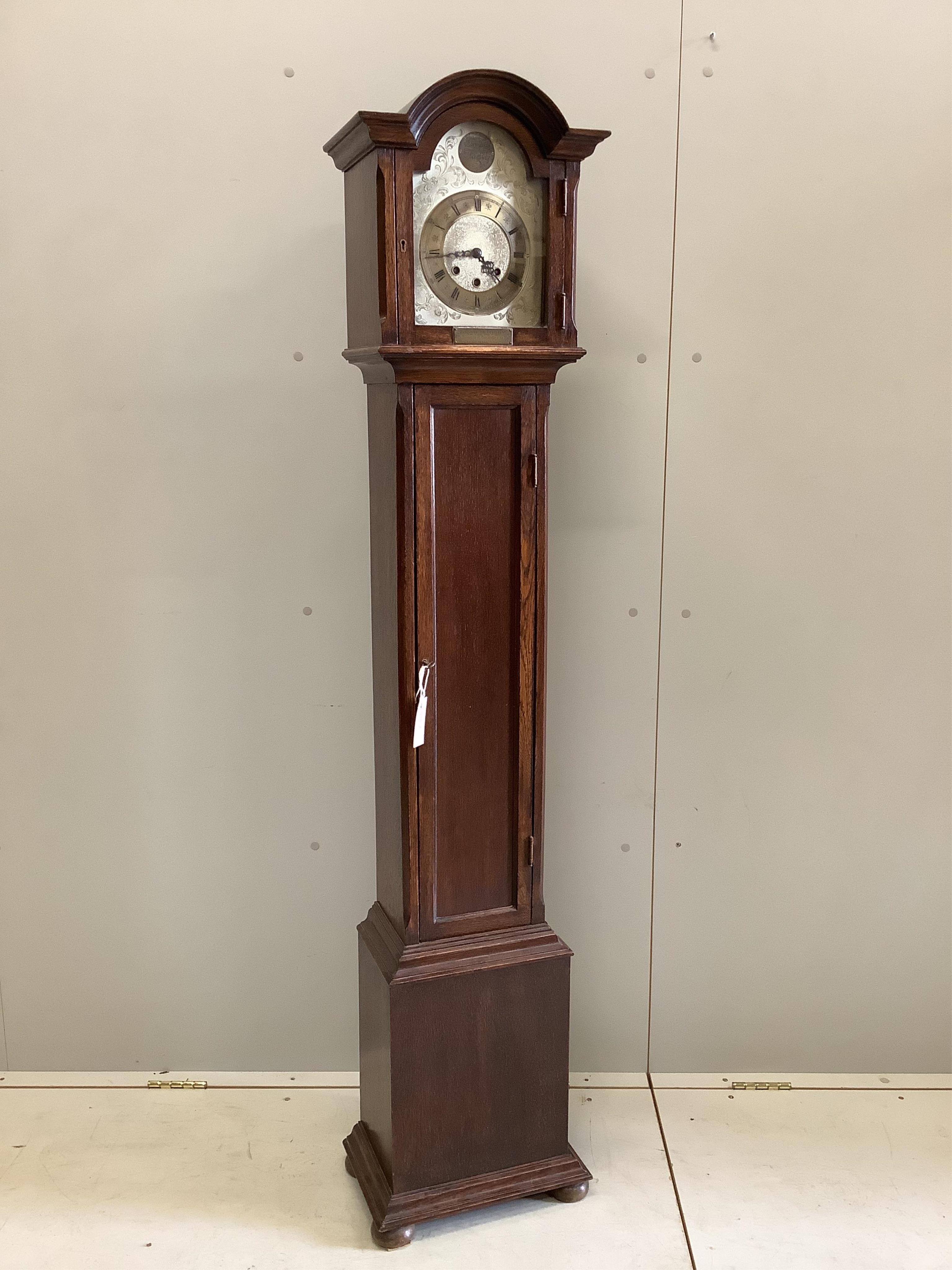 An early 20th century oak chiming grandmother clock with 1932 presentation plaque, height 167cm. Condition - fair to good, movement not tested